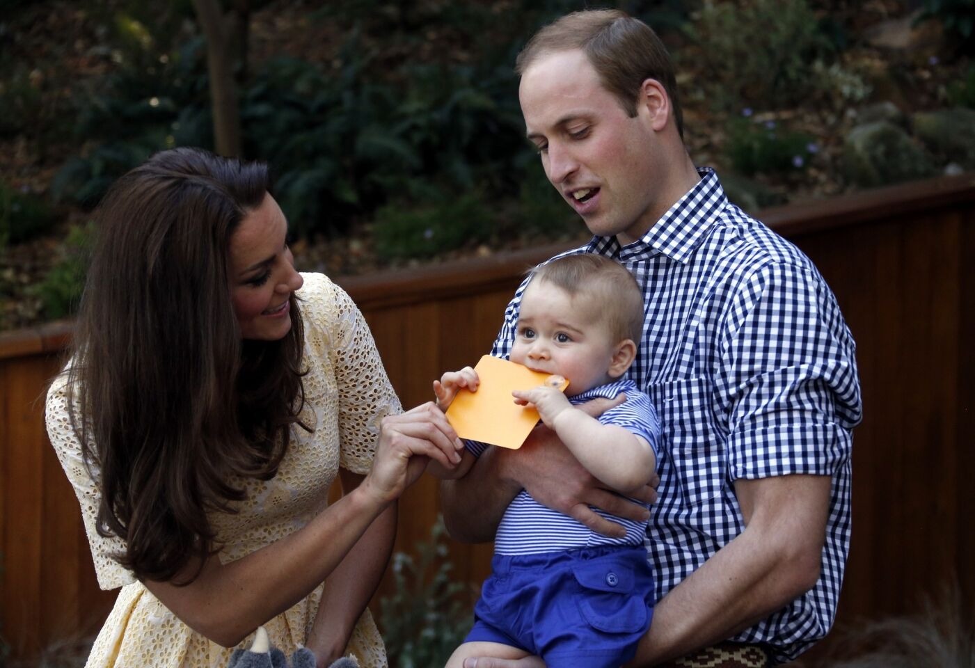 Catherine and William react as Prince George bites a small present that was given to him at Sydney's Taronga Zoo.