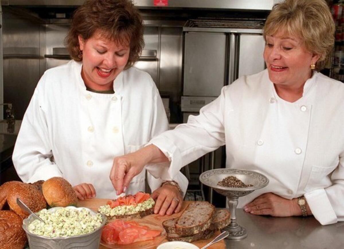 Susan Campoy, right, garnishes a smoked salmon and egg salad sandwich made by catering chef Kathy DeKarr. Campoy opened Julienne in 1985 in an effort to support her four daughters after her divorce.