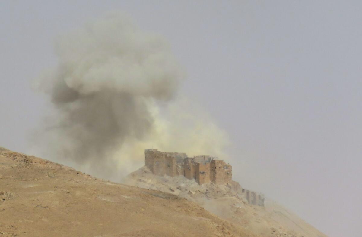 Smoke billows from the Palmyra citadel on March 25, 2016, during a military operation by Syrian troops to retake the ancient city from Islamic State.