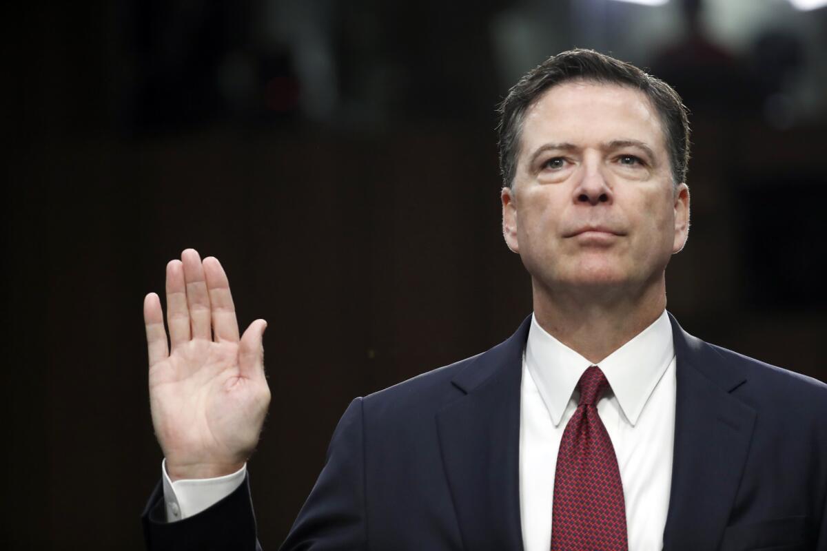 Former FBI Director James Comey is sworn in during a hearing before the Senate Select Committee on Intelligence in June. (Alex Brandon / Associated Press)