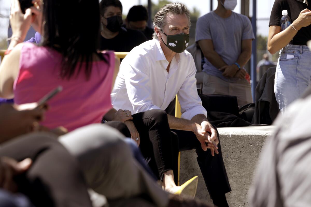 Gov. Gavin Newsom seated during a rally.