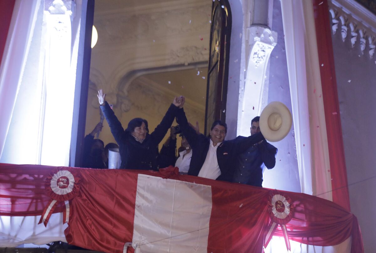 Pedro Castillo, center, celebrates with his running mate Dina Boluarte