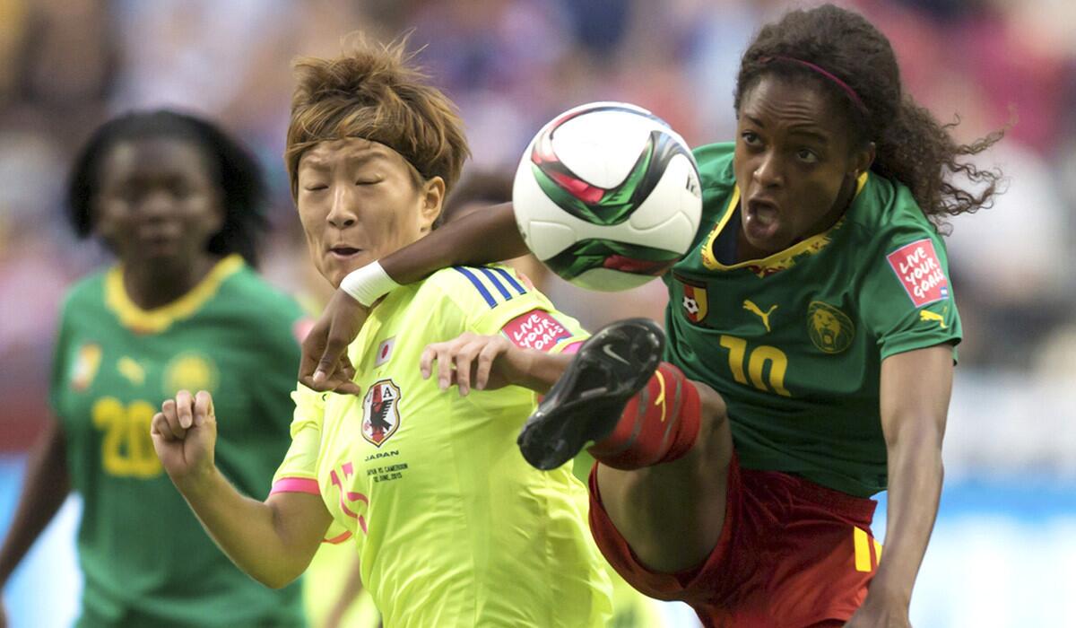 Cameroon's Jeannette Yango, right, jumps for the ball in front of Japan's Yuika Sugasawa during the first half of a FIFA Women's World Cup soccer match on Friday.