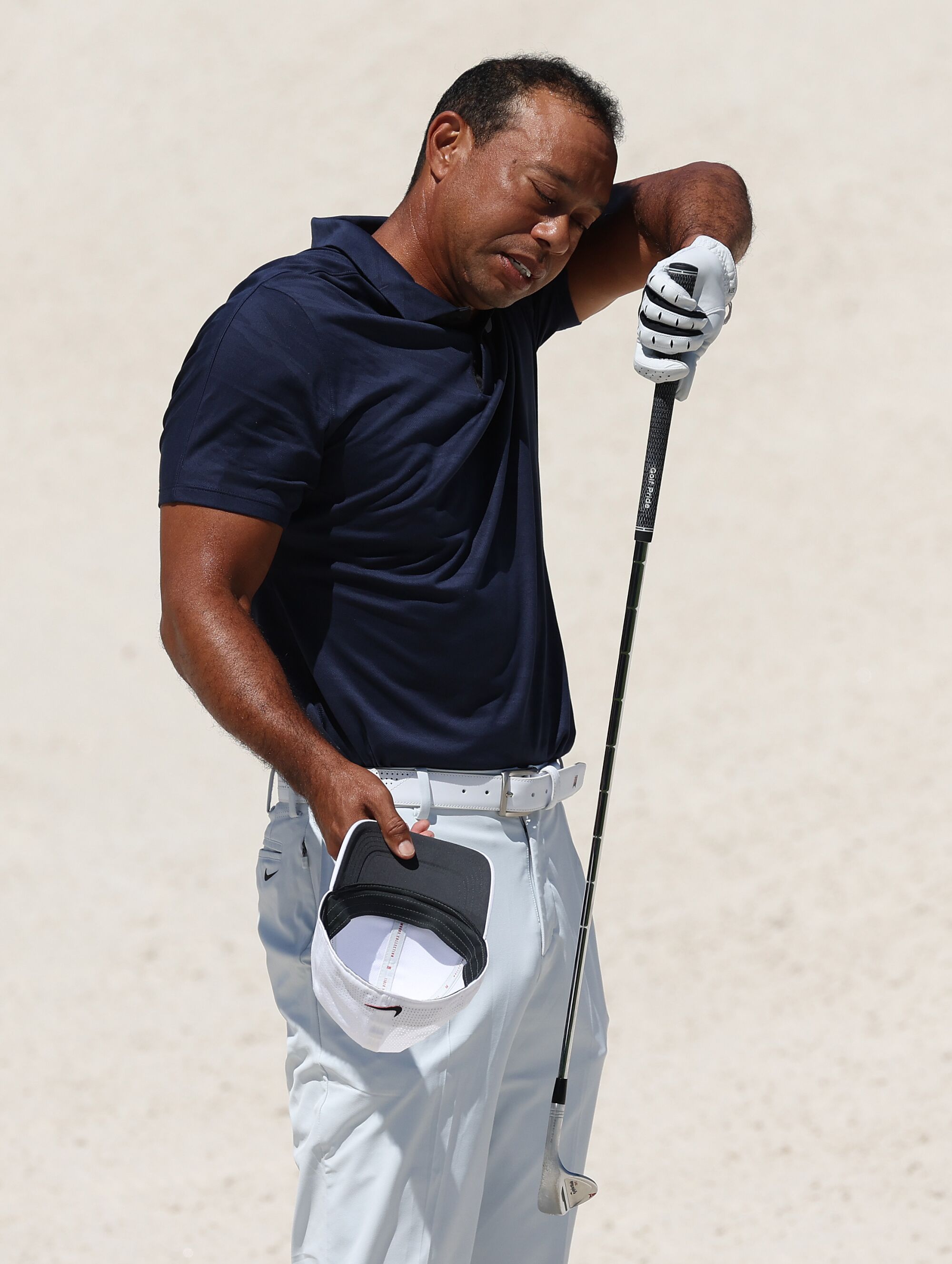 Tiger Woods wipes his face during a practice round before the Masters.