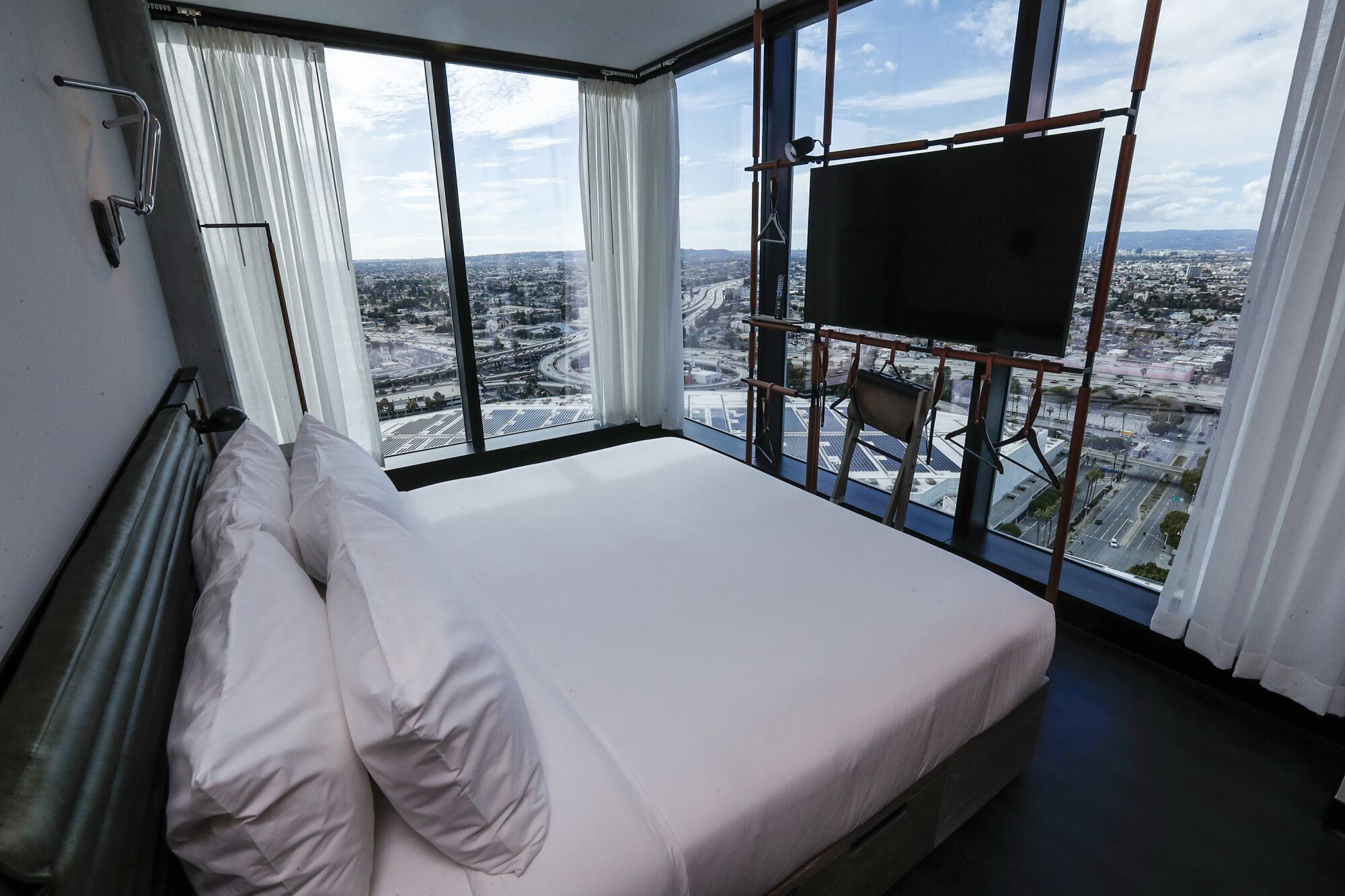 A room at the Moxy features sparse decor but a wide-ranging view of downtown L.A.