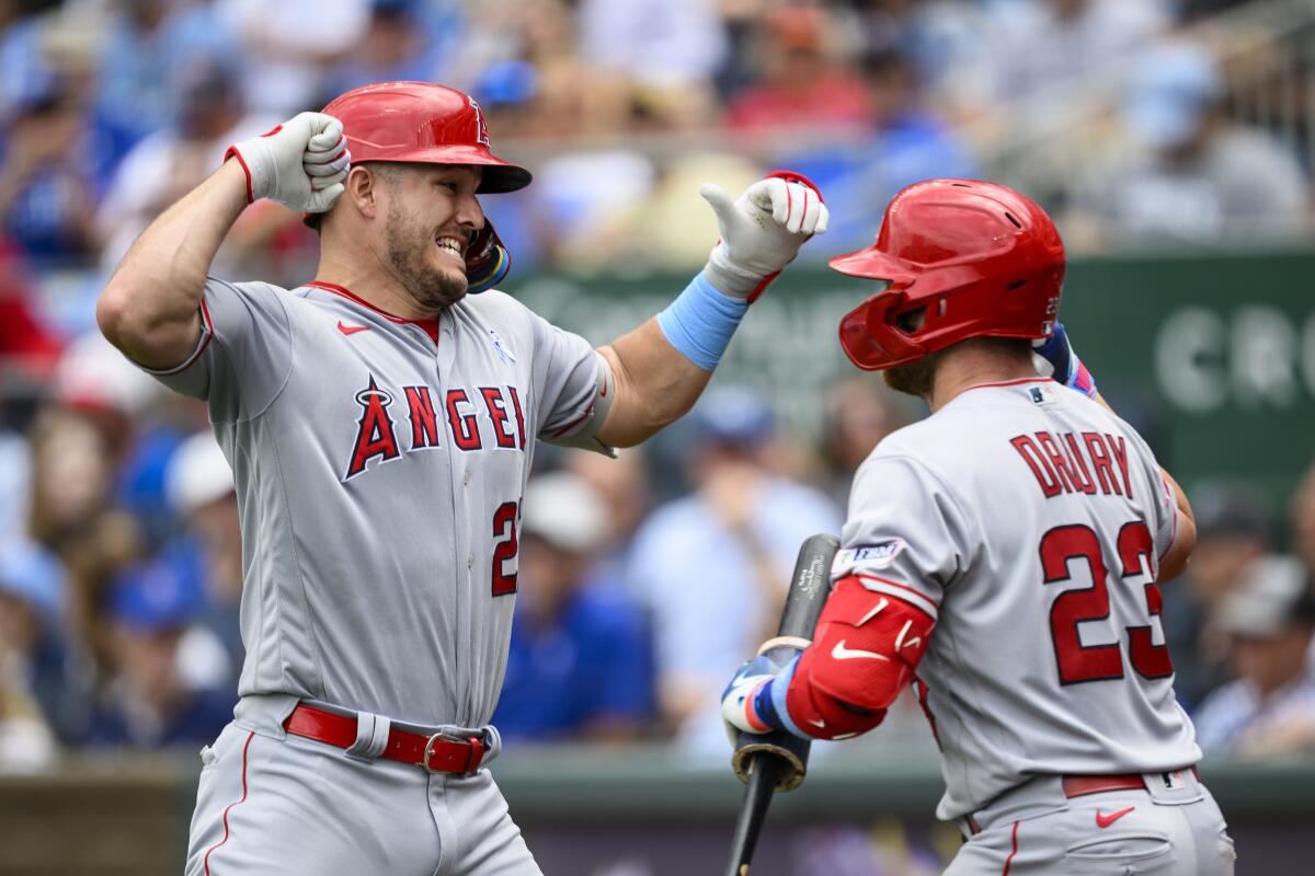 Angels star Mike Trout, left, celebrates with teammate Brandon Drury after hitting a home run in the fifth inning.