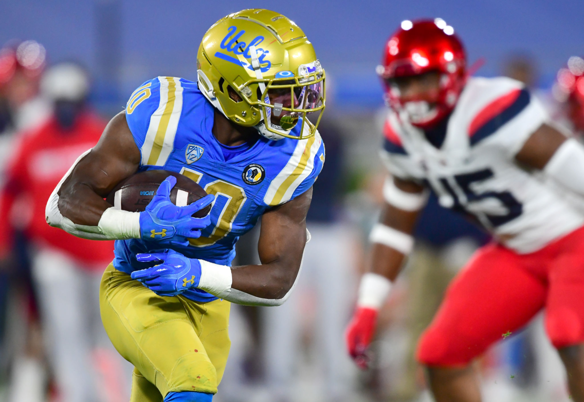 UCLA running back Demetric Felton Jr. carries the ball for a gain against Arizona.