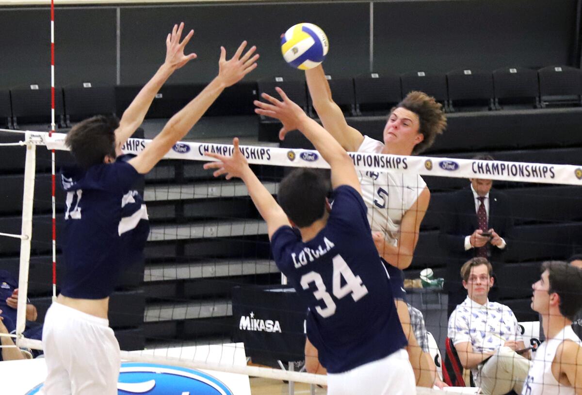 Newport Harbor's Riggs Guy (5) spikes the ball for a score during Saturday's Division 1 title match.