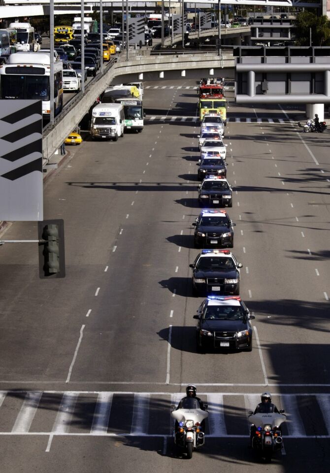 A motorcade, consisting of members of the L.A. Police Department, L.A. Fire Department, and honor guards with the Transportation Security Administration, carries a U.S. National Honor Flag in memory of TSA Officer Gerardo Hernandez.