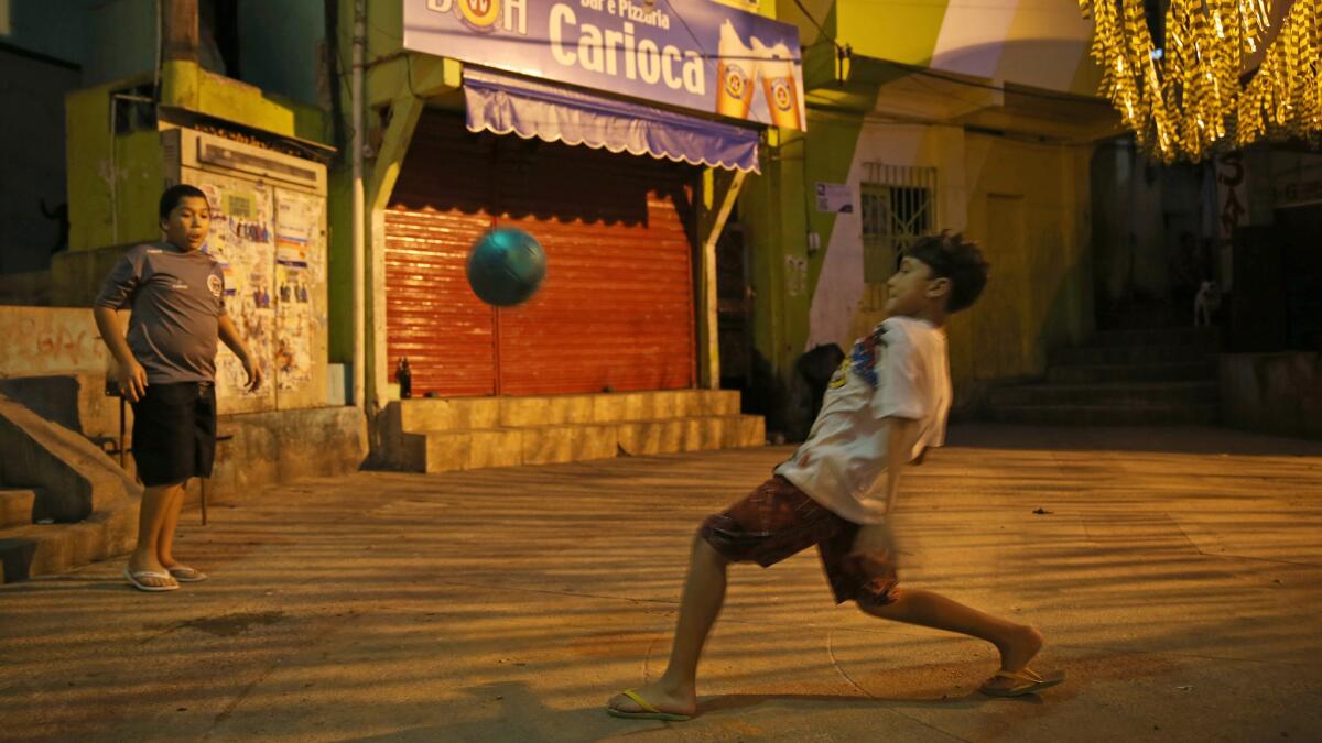 Children play a game of soccer in the streets of a favela in Rio de Janiero on Sunday. Many of Brazil's soccer stars came from humble beginnings where playing barefooted soccer in the streets was a part of life.