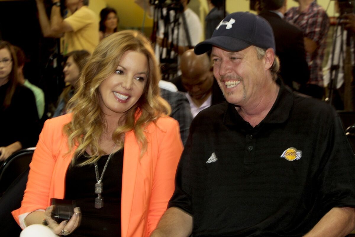 In her updated memoir, "Laker Girl," Lakers executive Jeanie Buss says she was 'devastated' after her brother, Jim Buss, right, decided he wouldn't hire Phil Jackson to replace the fired Mike Brown as coach.