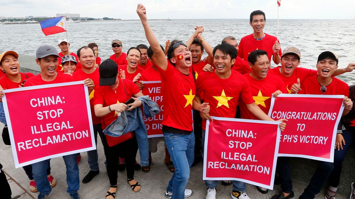Vietnamese expatriates cheer at a rally by Manila's baywalk before the U.N. international tribunal announced its ruling on the South China Sea on Tuesday. The Vietnamese are supporting the Philippines' case.