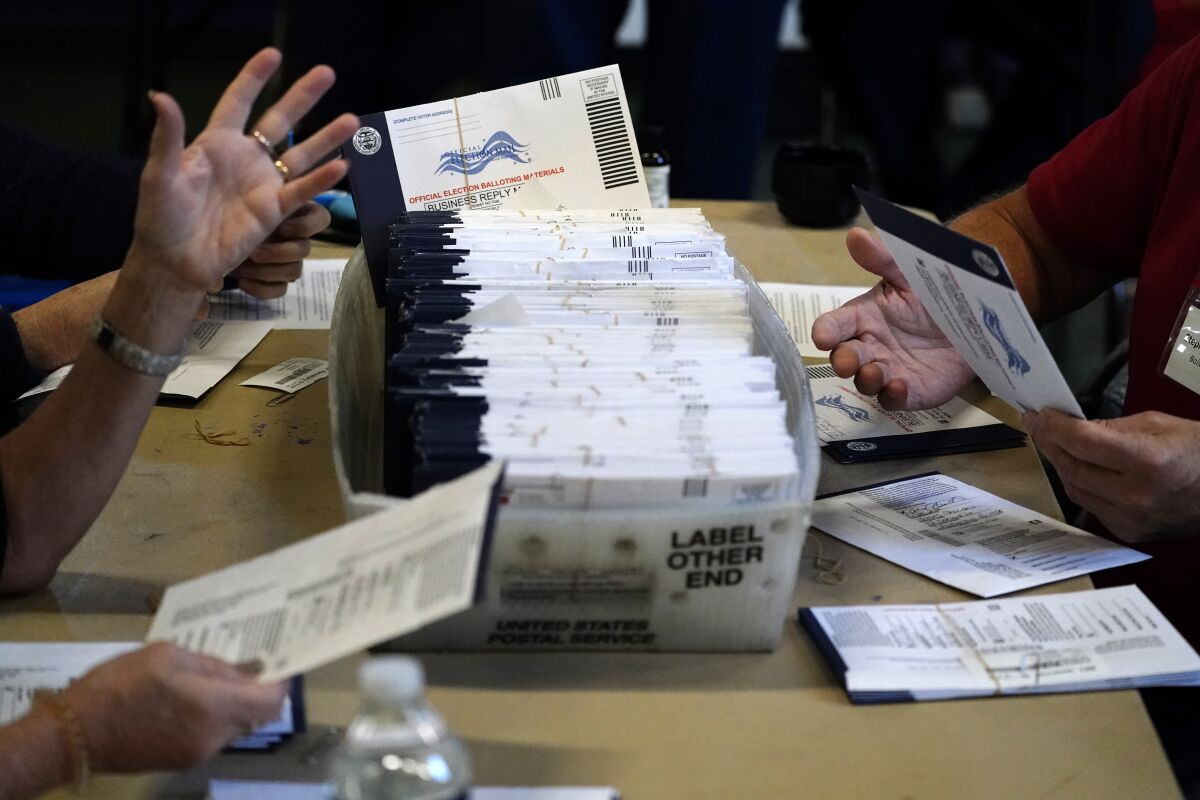 Chester County election workers process mail-in and absentee ballots for the 2020 general election in the United States at West Chester University, Wednesday, Nov. 4, 2020, in West Chester, Pa. (AP Photo/Matt Slocum)