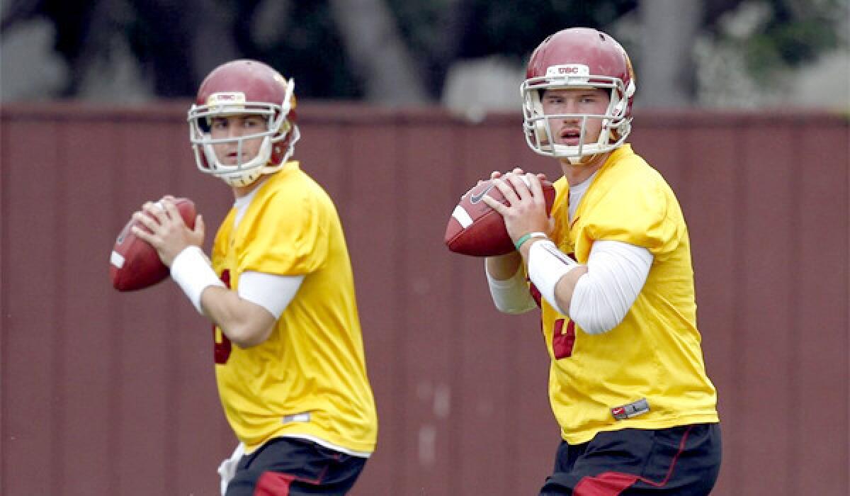 In USC's first scrimmage in preparation for the Trojans' Aug. 29 opener at Hawaii, quarterbacks Cody Kessler, left, and Max Wittek, right, completed a combined 25 of 36 passes for 314 yards and three touchdowns.