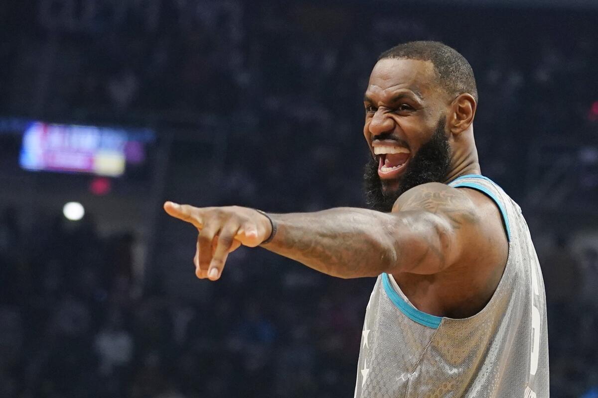 Lakers star LeBron James jokes with fans during the NBA All-Star game in Cleveland on Feb. 20.