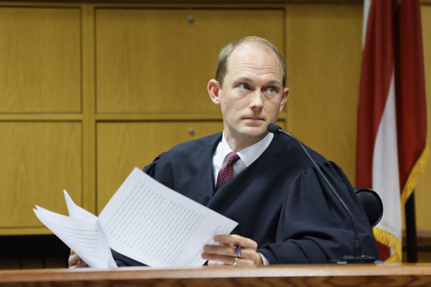 Fulton County Superior Court Judge Scott McAfee hears motions from attorneys representing Kenneth Chesebro and Sidney Powell in Atlanta on Thursday, Sept. 14, 2023. Donald Trump will not face trial next month in Georgia after McAfee ruled Thursday that the former president and 16 others accused of illegally trying to overturn the results of the 2020 election will be tried separately from two lawyers in the case. Lawyers Powell and Chesebro had filed demands for a speedy trial, and McAfee set their trial to begin Oct. 23. (Miguel Martinez/Atlanta Journal-Constitution via AP, Pool)