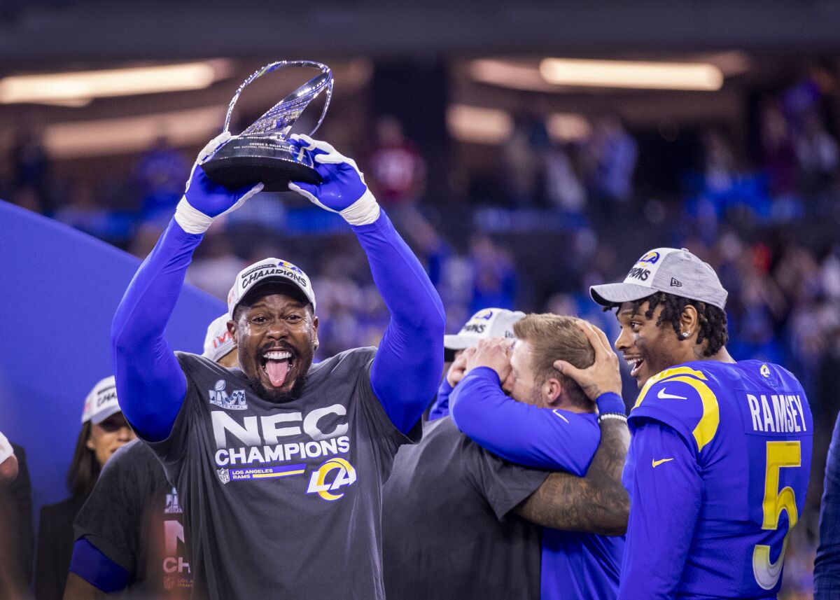 Rams linebacker Von Miller hoists the NFC championship trophy after beating the 49ers in the NFC title game.