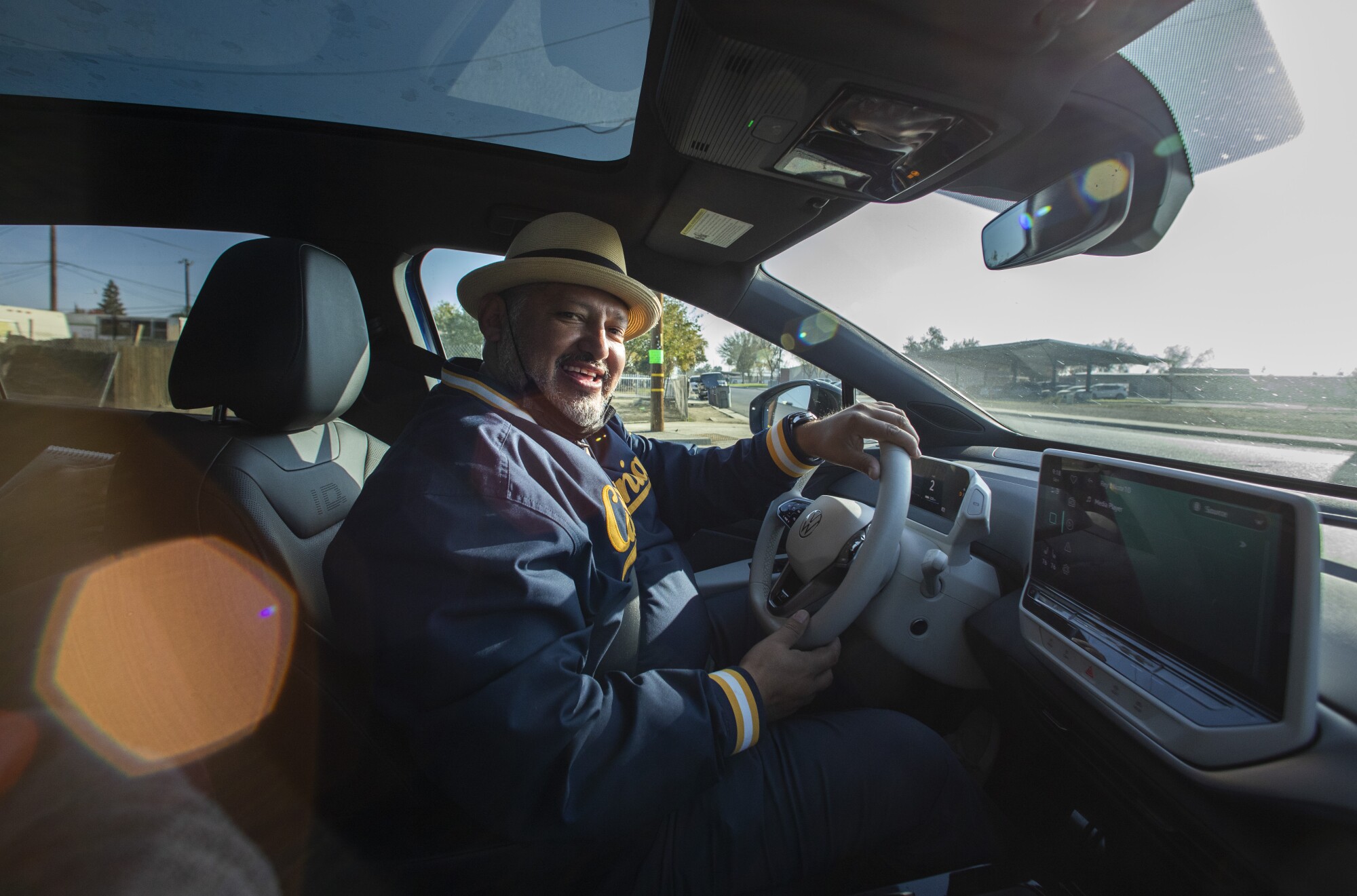 Huron Mayor Rey León smiles as he drives on the Green Raiteros electric vehicles. 