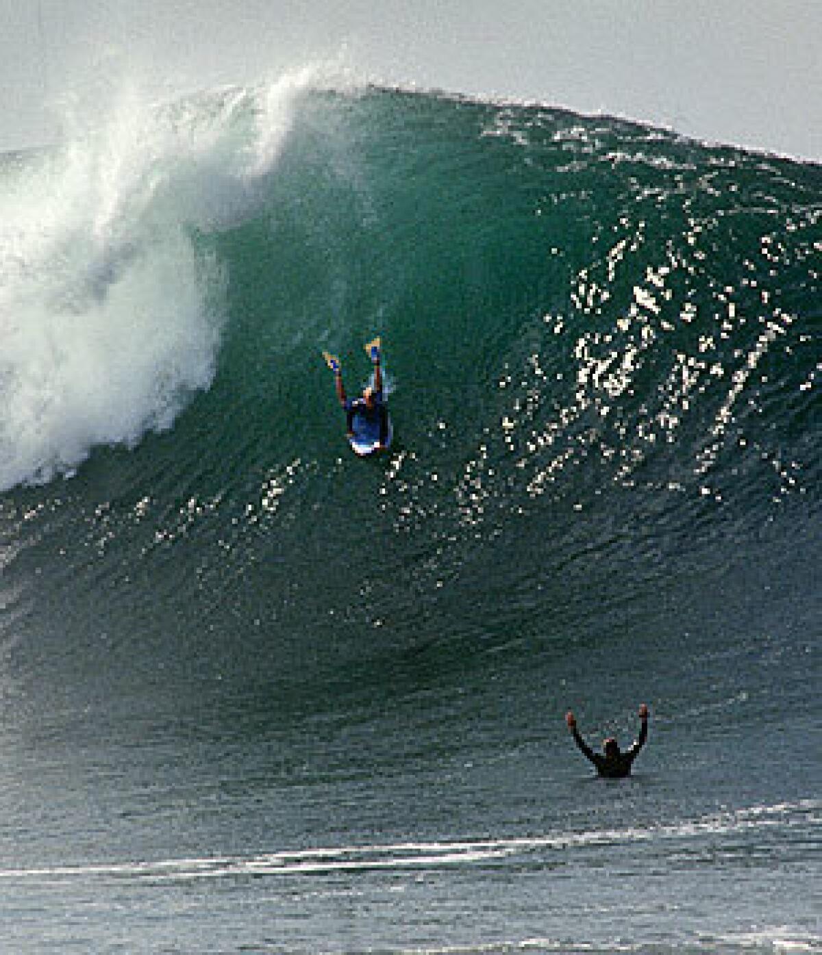 Waves up to 25 feet crash into a body-munching shore break at the Wedge. Pro bodyboarder Mike Stewart drops in July 1996.
