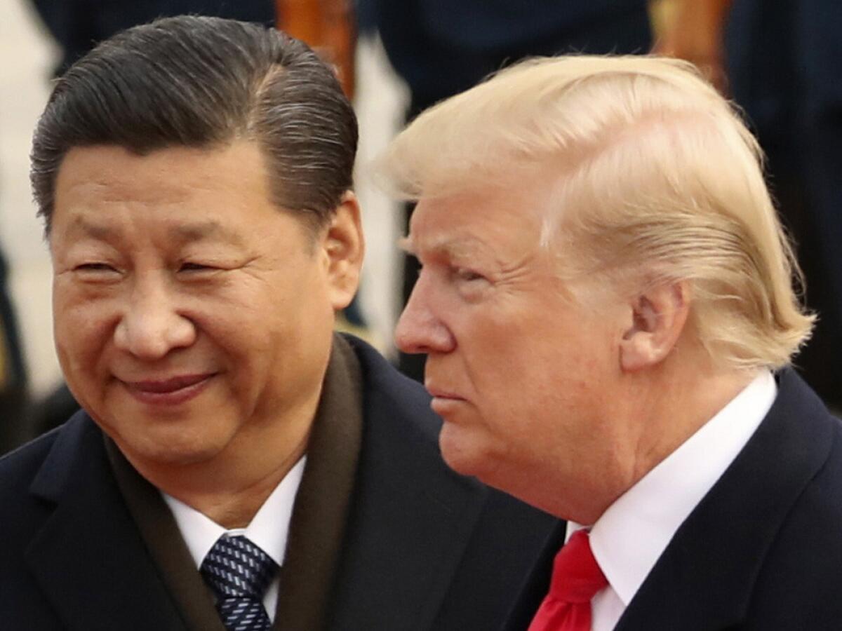 FILE - In this Nov. 9, 2017, file photo, U.S. President Donald Trump and Chinese President Xi Jinping in Beijing, China. 