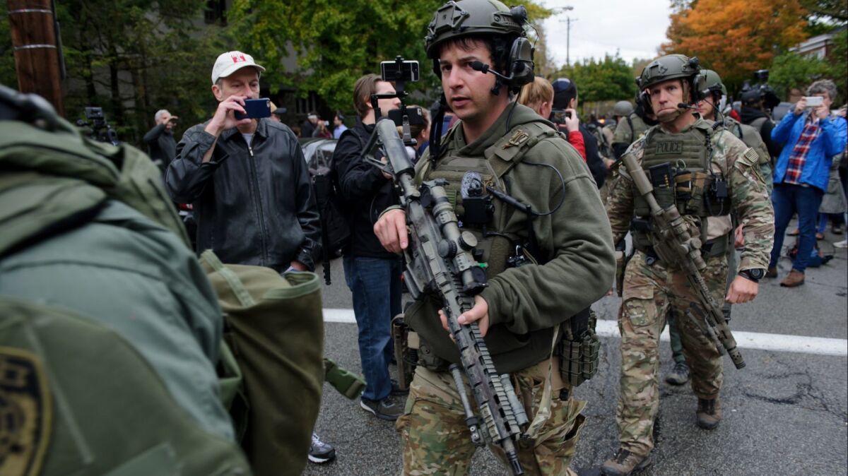 SWAT members leave the scene of a mass shooting at the Tree of Life Synagogue in the Squirrel Hill neighborhood of Pittsburgh on Saturday.