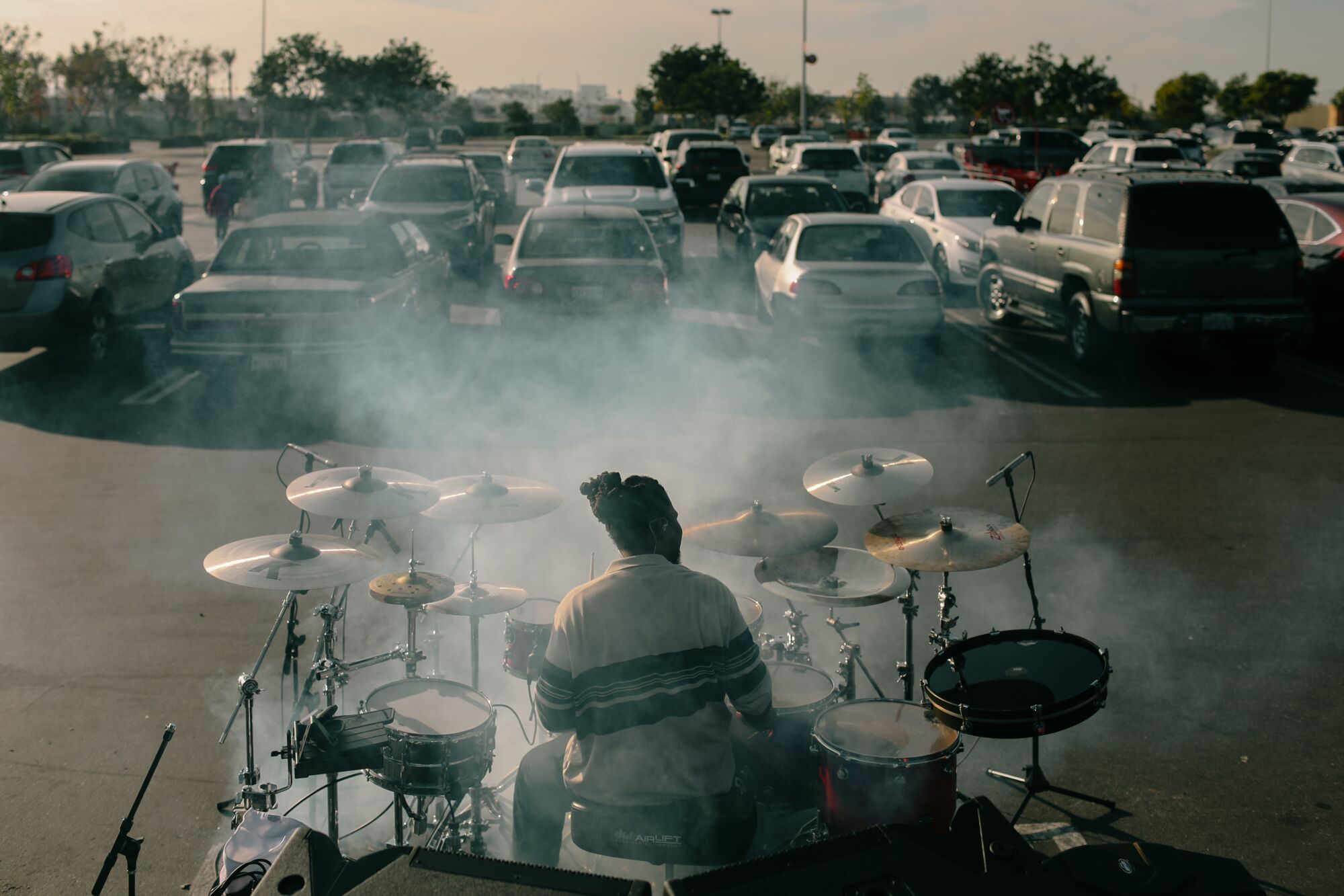  A man sits behind a massive drum kit