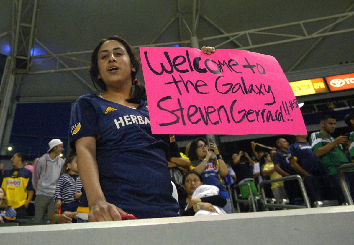 A fan holds up a sign for Los Angeles Galaxy midfielder Steven Gerrard, of England, prior to an International Champions Cup soccer match against Club America, Saturday, July 11, 2015, in Carson, Calif. (AP Photo/Mark J. Terrill)