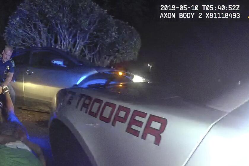 This image from video from Louisiana state police state trooper Dakota DeMoss' body-worn camera, shows trooper Kory York grabbing the leg shackles and dragging Ronald Greene on his stomach on May 10, 2019, outside of Monroe, La. The video obtained by The Associated Press shows Louisiana state troopers stunning, punching and dragging the Black man as he apologizes for leading them on a high-speed chase, footage authorities refused to release in the two years since Greene died in police custody. (Louisiana State Police via AP)