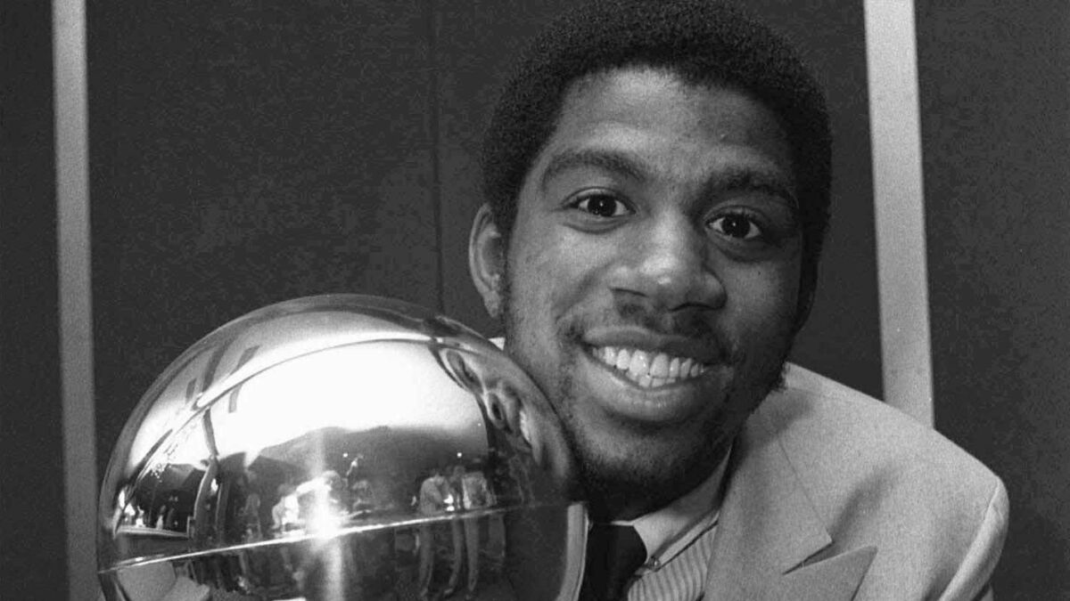 Lakers rookie Magic Johnson holds the Sport Magazine National Basketball Association's trophy.
