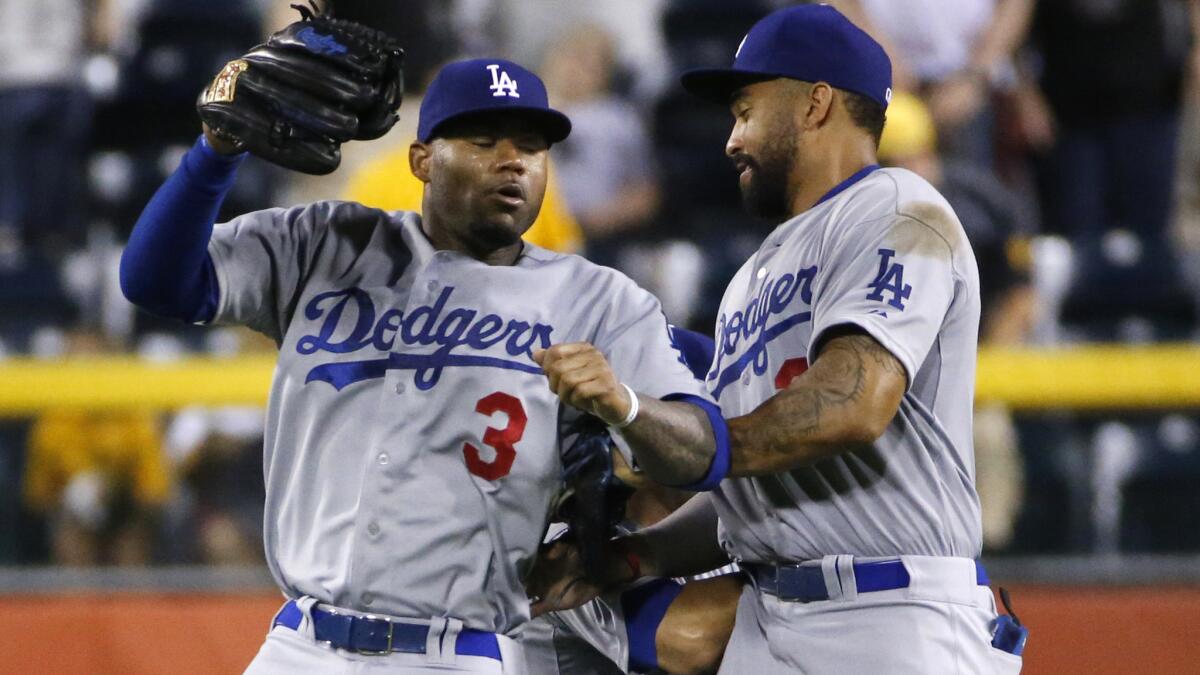 Dodgers outfielders Carl Crawford, left, Andre Ethier, center, and Matt Kemp celebrate after a win over the Pittsburgh Pirates on July 21. Will there be fewer outfielders on the Dodgers' roster by the trade deadline?