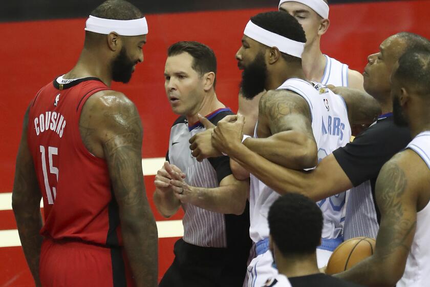 Los Angeles Lakers forward Markieff Morris, right, gets into an altercation with Houston Rockets center DeMarcus Cousins (15) during the first quarter of an NBA basketball game on Sunday, Jan. 10, 2021, at Toyota Center in Houston. Morris was ejected from the game after the incident. (Brett Coomer/Houston Chronicle via AP)