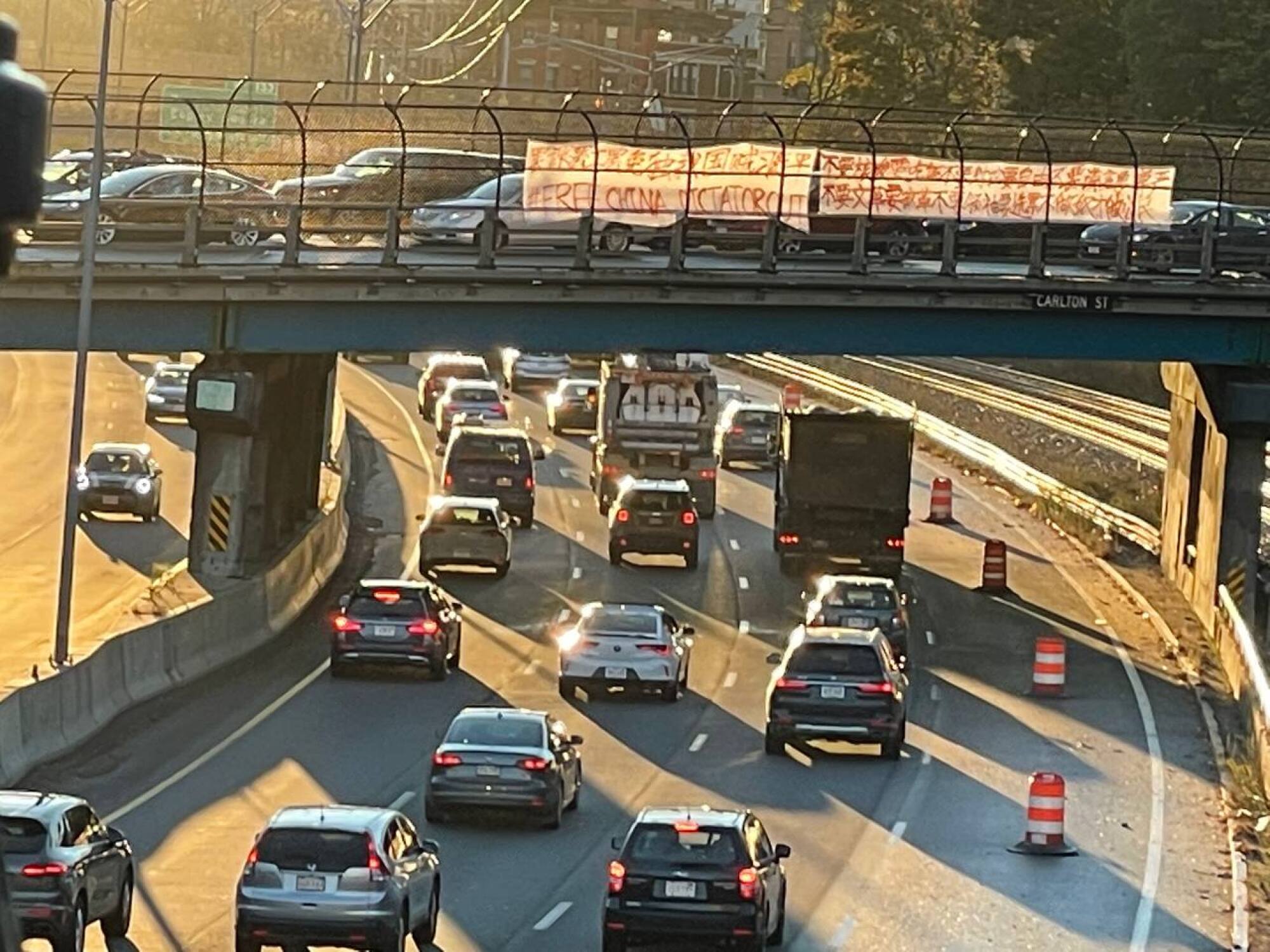 A banner protesting China's government hangs on a highway overpass in Boston