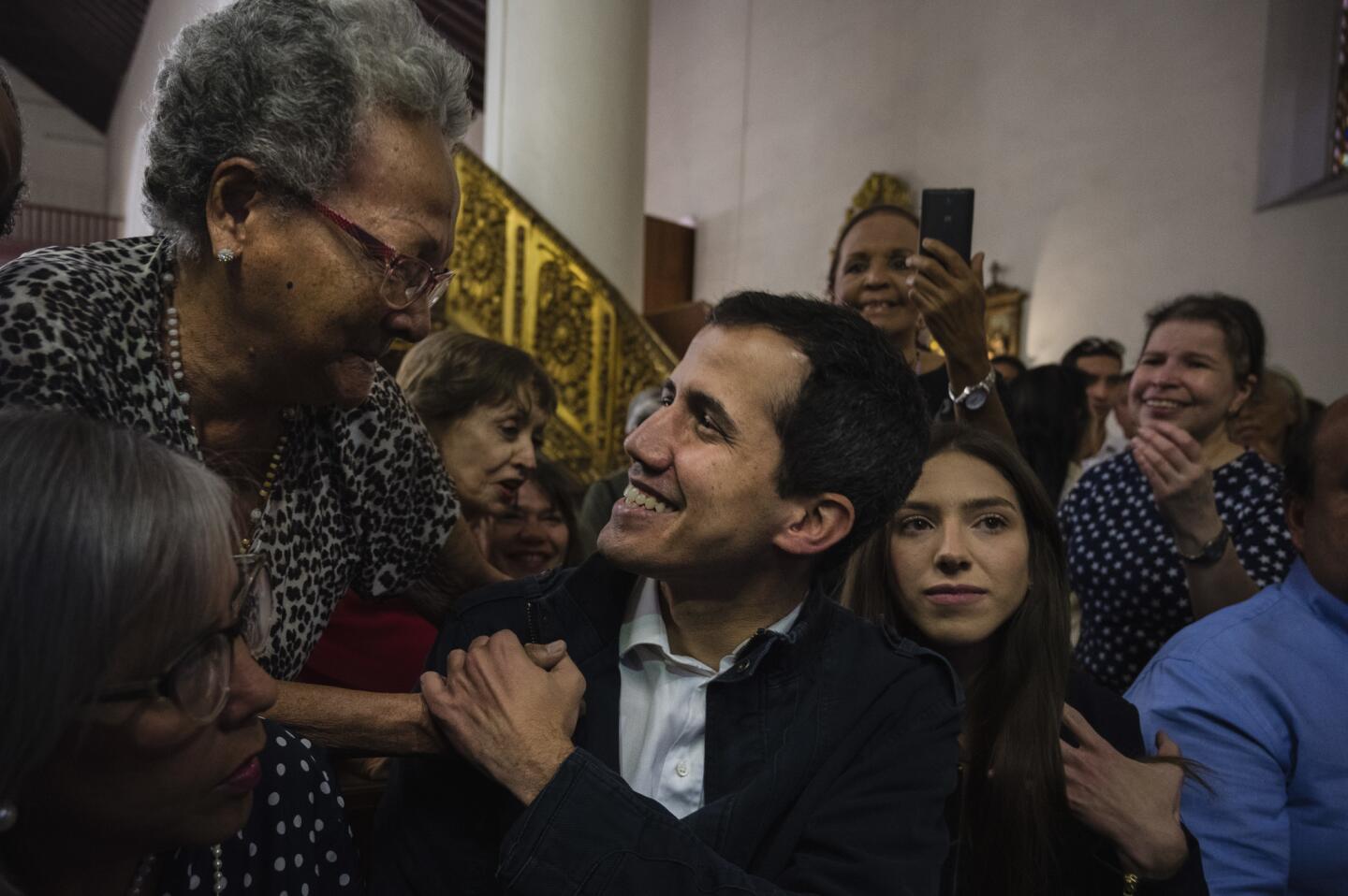 Opposition leader Juan Guaido and his family attend a Mass in honor of Venezuelans killed during the protests in Caracas, Venezuela, on Jan. 27.