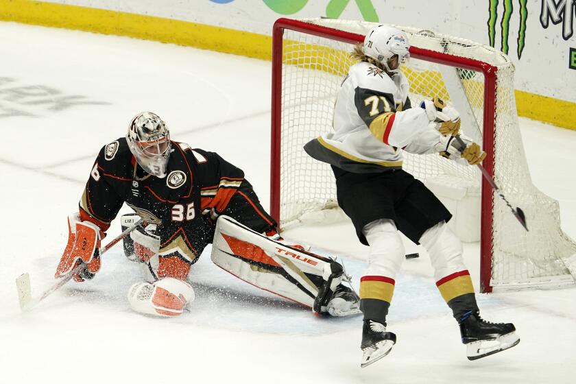 Vegas Golden Knights center William Karlsson, right, scores the game-winner past Anaheim Ducks.