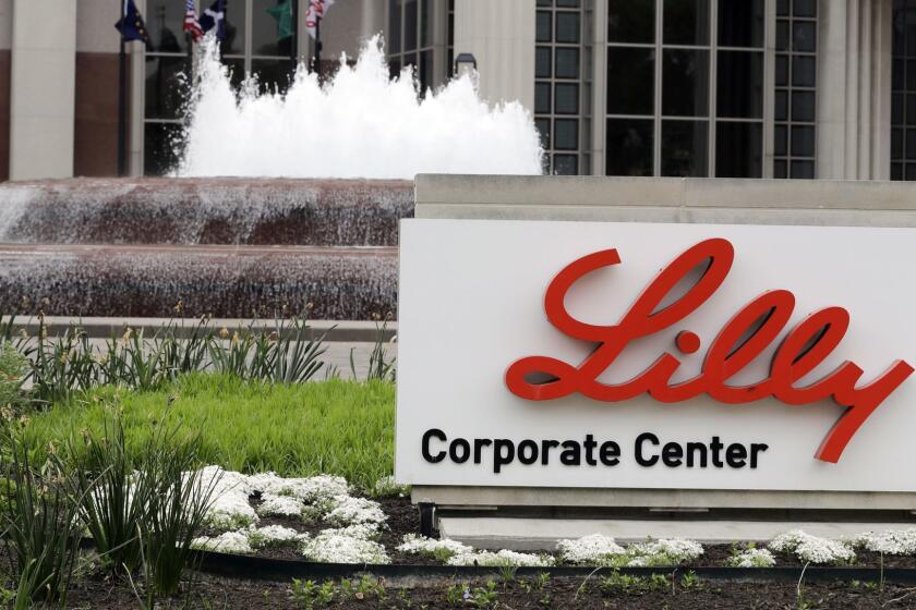 FILE- This April 26, 2017, file photo shows the Eli Lilly and Co. corporate headquarters in Indianapolis. Eli Lilly is offering a half-price version of its top-selling insulin Humalog as drugmakers face growing pressure to control prices. The drugmaker says it will introduce a version of the diabetes treatment called Insulin Lispro with a list price 50 percent lower than its current rate, about $275 per vial. (AP Photo/Darron Cummings, File)