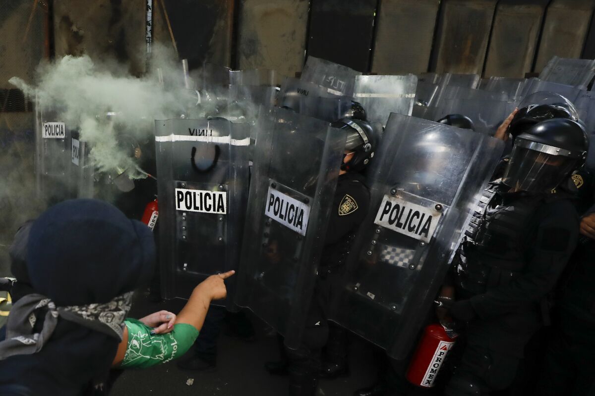 Anarchist protesters face off against police in the Polanco neighborhood of Mexico City