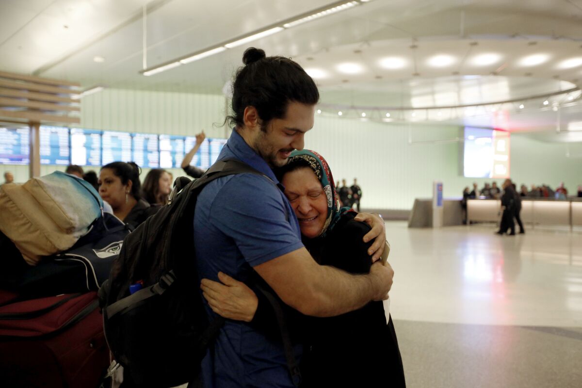 Siavosh Naji-Talakar greets his grandmother, Marzieh Moosavizadeh, 75, at LAX's Tom Bradley International Terminal. She was detained upon arriving from Iran.