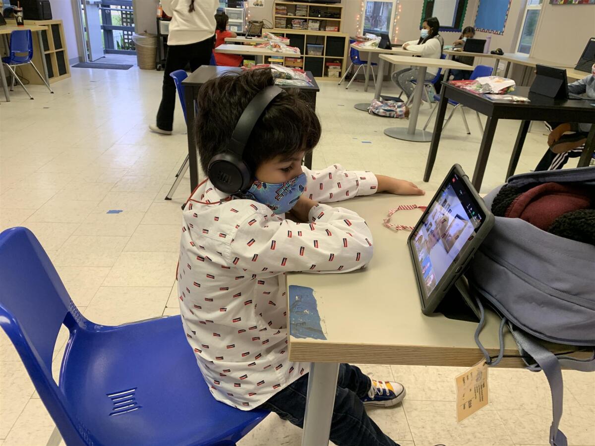 A child logs into the online Christmas party.