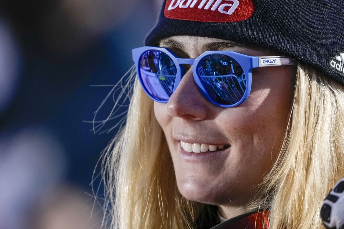 United States' Mikaela Shiffrin follows the competition in the finish area of an alpine ski, women's World Cup super-G, in Lenzerheide, Switzerland, Saturday, March 5, 2022. (AP Photo/Giovanni Auletta)