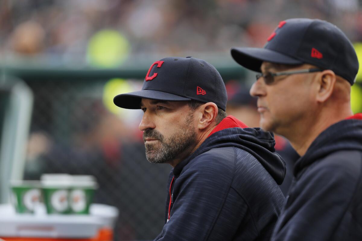 Cleveland Indians pitching coach Mickey Callaway watches from the dugout with manager Terry Francona.