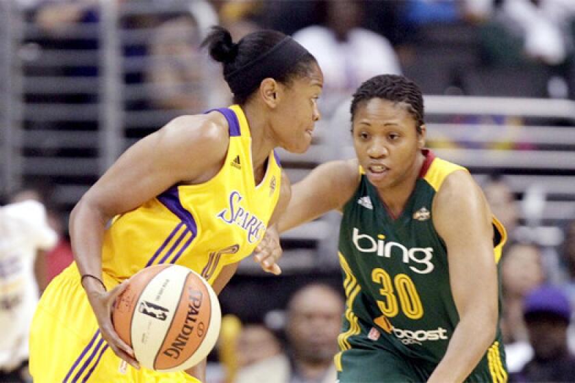 Alana Beard looks for a hole in the lane to drive on Tanisha Wright during the Sparks' 102-69 victory over the Seattle Storm on May 26, 2013.