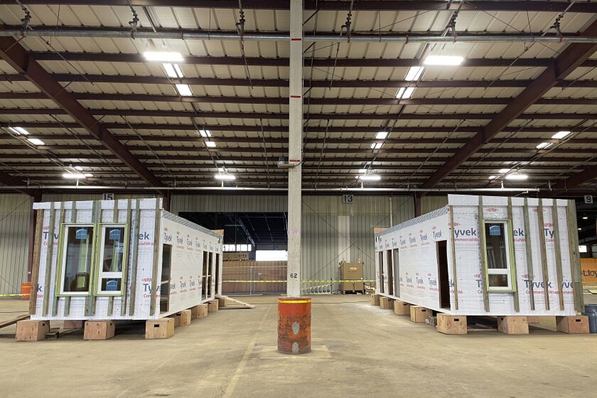 Mass timber affordable home prototypes are shown at the Port of Portland in Portland, Ore. Friday, Jan. 27, 2023. The prototype was built in a warehouse at the port. The Oregon Mass Timber Coalition aims to open a factory at the site that could mass produce homes and potentially alleviate the state's housing shortage. (AP Photo/Claire Rush)