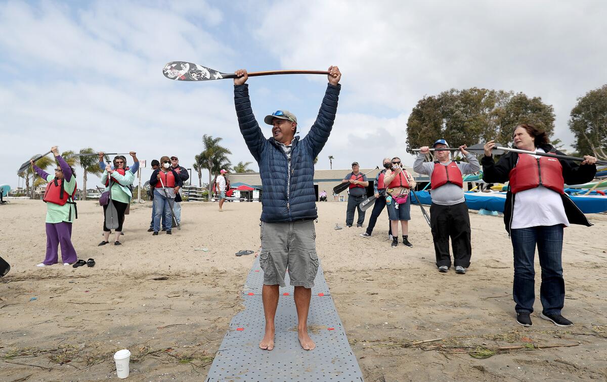 RJ De Rama, founder of Makapo Aquatics Project, instructs paddlers at the Newport Aquatics Center.