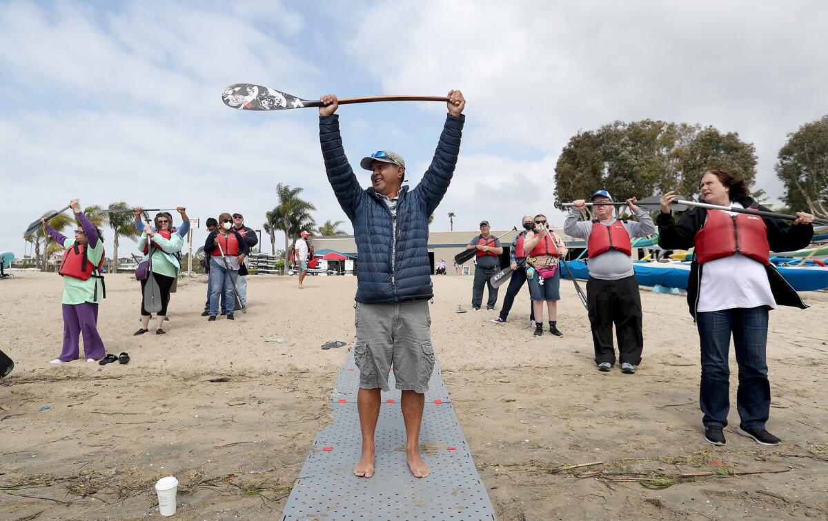 RJ De Rama, founder of Makapo Aquatics Project, instructs paddlers at the Newport Aquatics Center. 