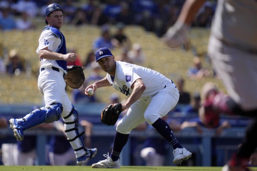 Los Angeles Dodgers starting pitcher Jack Flaherty, center, throws out Cleveland Guardians' Josh Naylor.