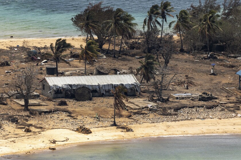 FILE - In this photo provided by the Australian Defense Force, debris from damaged building and trees are strewn around on Atata Island in Tonga on Jan. 28, 2022, following the eruption of an underwater volcano and subsequent tsunami. Coronavirus cases continue to rise rapidly in Tonga, and tests have confirmed that the particularly contagious omicron variant is behind the isolated Pacific island nation's first community outbreak since the start of the pandemic, officials said Thursday, Feb. 10, 2022. (POIS Christopher Szumlanski/Australian Defense Force via AP, File)