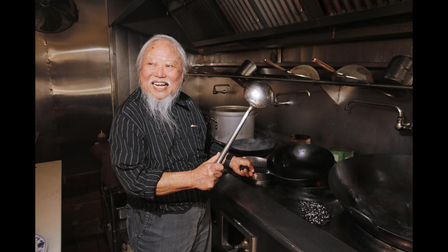 Cheong Kwon Lee laughs as he takes his former chef position at Shanghai Pine Gardens on Balboa island. Mr. Lee retired about 30 years ago and was recently inducted into the historical society of Balboa Island.