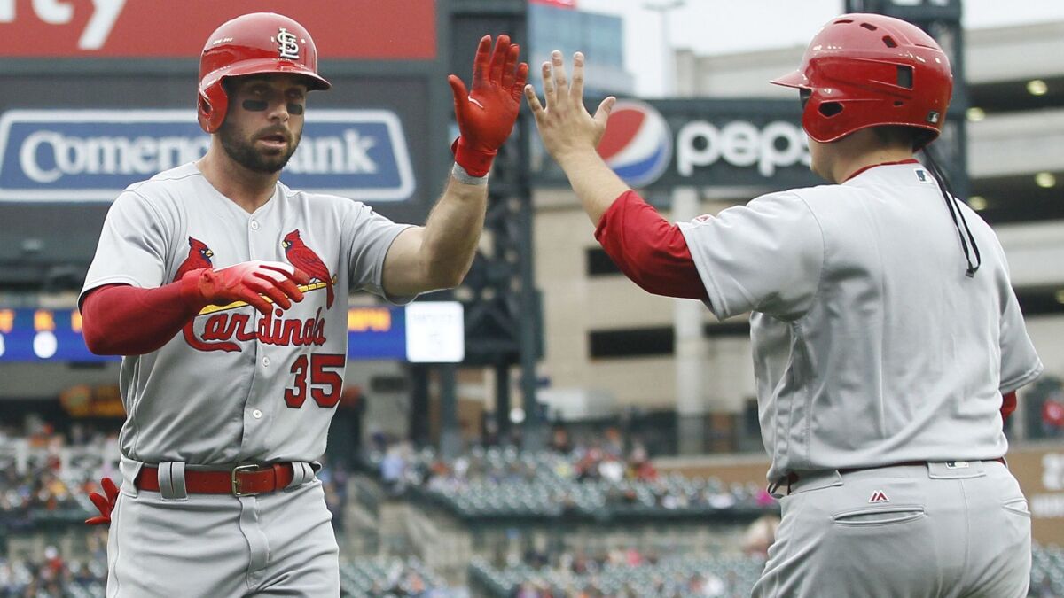 Greg Garcia of the St. Louis Cardinals celebrates after scoring against the Detroit Tigers on September 9.