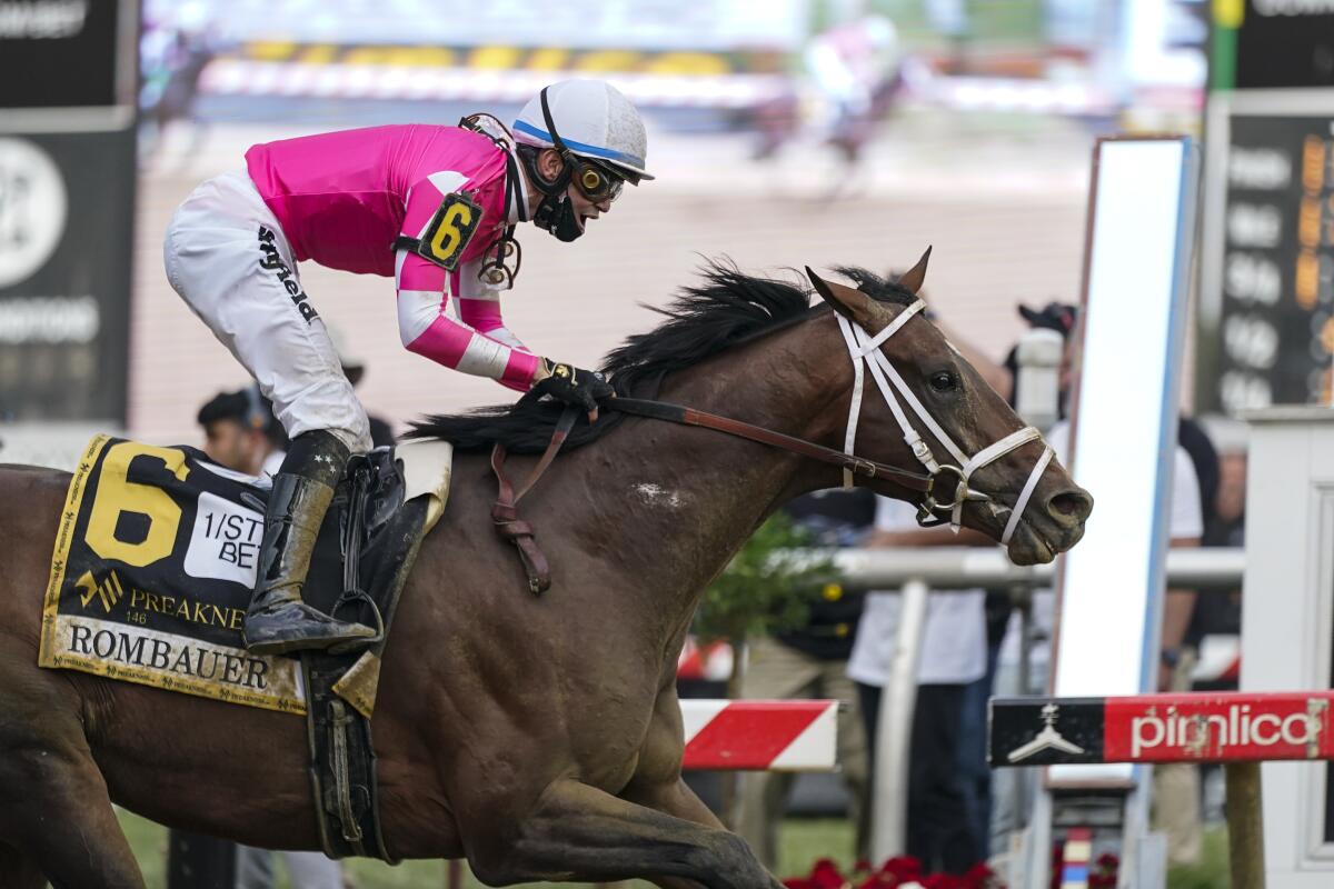 Flavien Prat atop Rombauer reacts as he crosses the finish line to win the Preakness Stakes in Baltimore on May 15, 2021.
