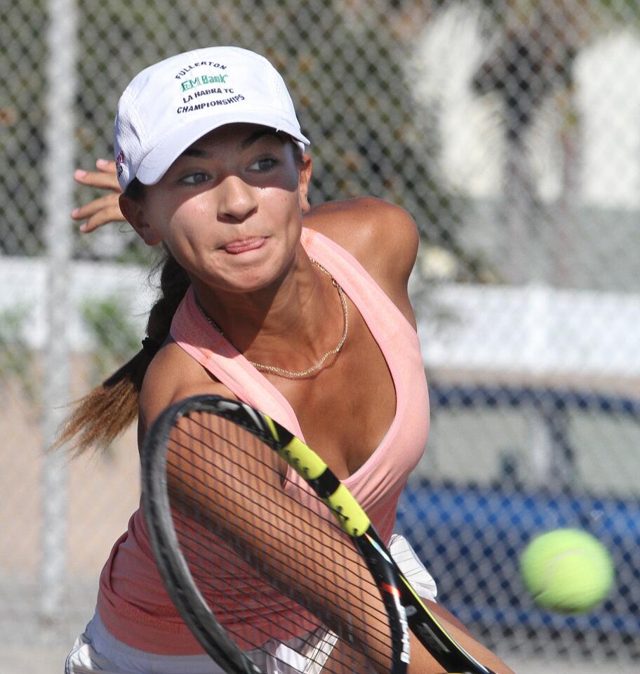 La Ca-ada's Sophie McKenzie reaches for a near-net return against San Marino's Madeleine Gandawidjaja and Libby Chang in the Rio Hondo League doubles finals for the league championship at Live Oak Park tennis courts in Temple City on Thursday, October 29, 2015. The McKenzie sisters won the match.
